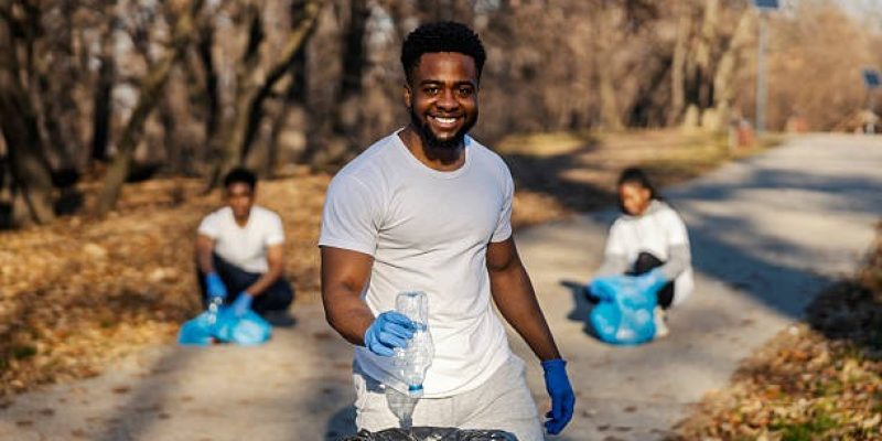 imgi_54_portrait-of-multicultural-smiling-ecology-volunteer-putting-plastic-bottle-into-garbage-bin